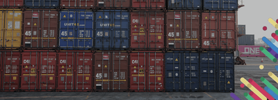 a large stack of cargo containers sitting on top of a tarmac