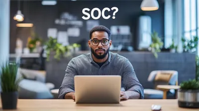 a man sitting in front of a laptop computer
