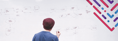 a man writing on a whiteboard with a marker