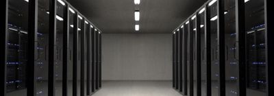 a long hallway with rows of servers in a data center