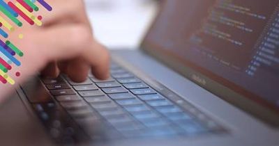 a close up of a person typing on a laptop