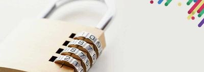 a padlock on a white wall with colorful paint splatters