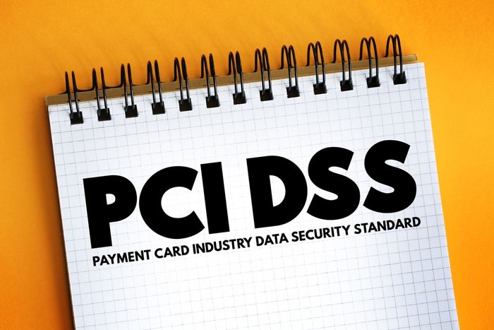 a notepad with the words PCI DSS on it