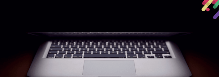 a laptop computer sitting on top of a wooden desk