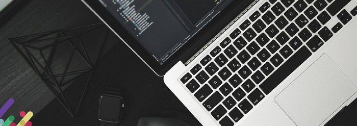 a laptop computer sitting on top of a desk