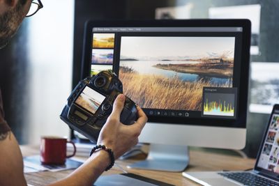 A photographer editing landscape pictures.
