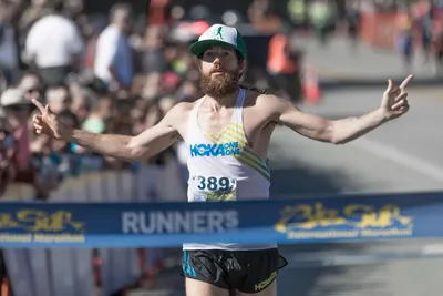 a man with a beard running in a marathon