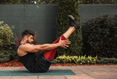 a man doing a yoga pose on a mat