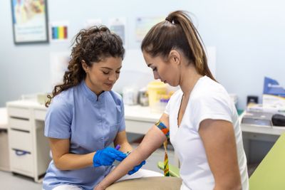 Doctor taking a blood sample from a patient in order to measure inflammation via key inflammatory markers