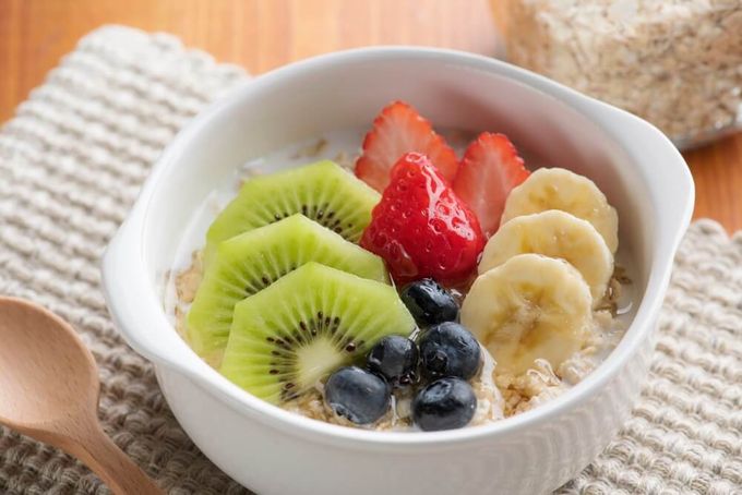 a bowl of oatmeal with soluble fiber  fruit on top