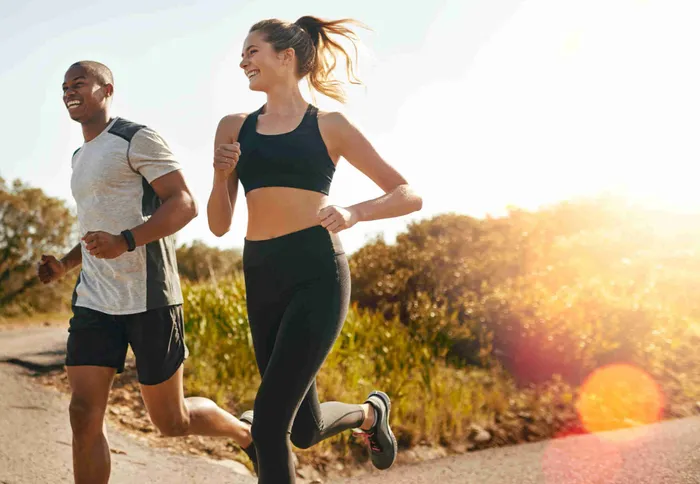 a man and a woman running down a road:Maximizing Vitamin D Absorption: Can you Get Vitamin D From the Sun After 4 pm