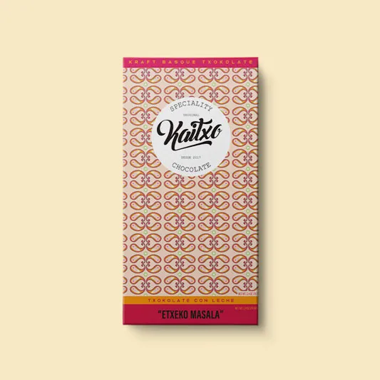 A Kaitxo Etxeco Masala chocolate bar on a yellow background.