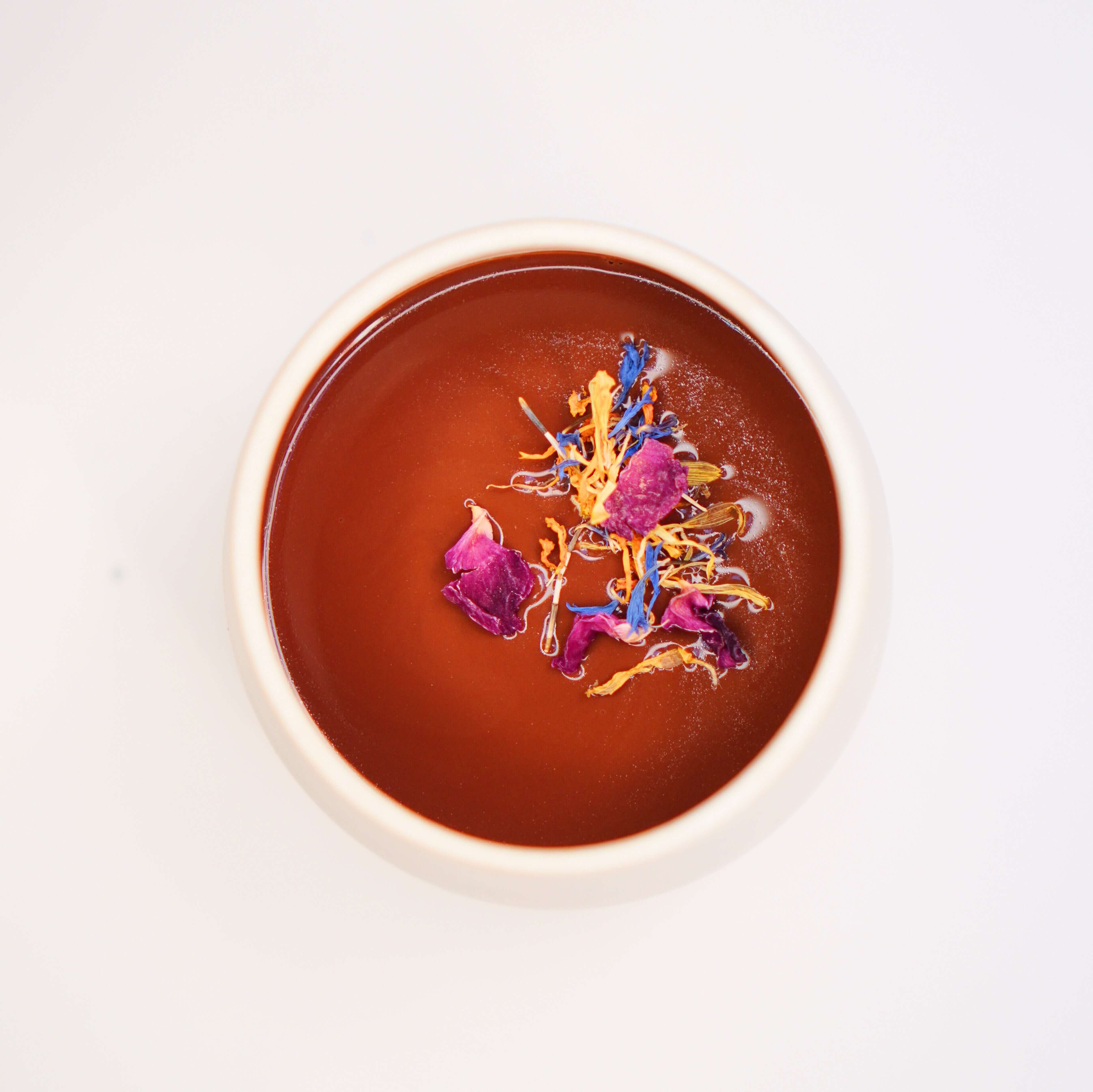 a white bowl filled with a Kaikao's 100% Ritual (Ceremonial) Drinking Cocoa from Hacienda Limon, Ecuador