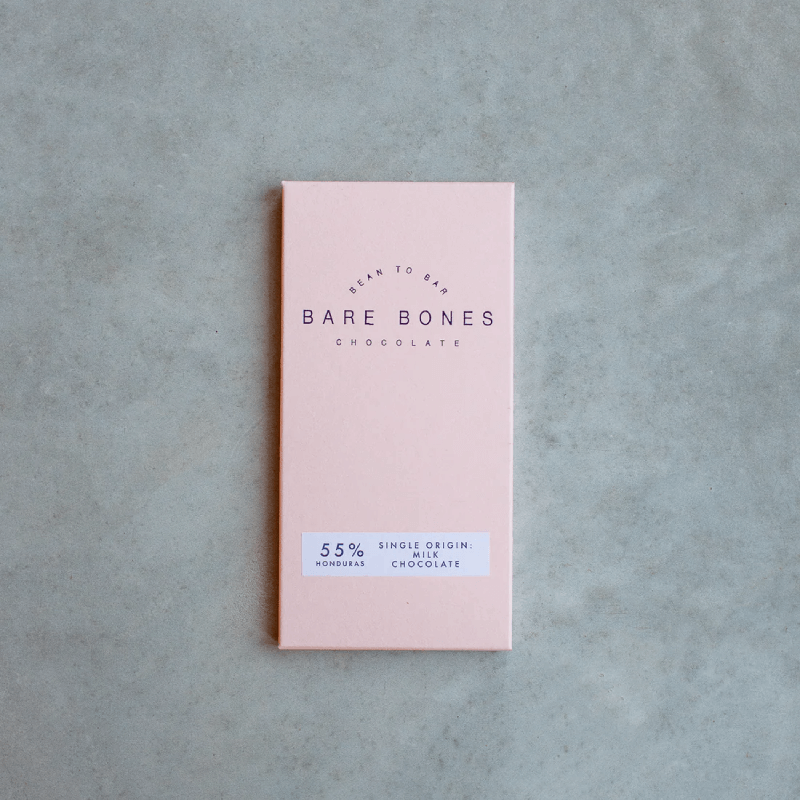 A Pink slab of Bar Bones Chocolate sitting on top of a counter