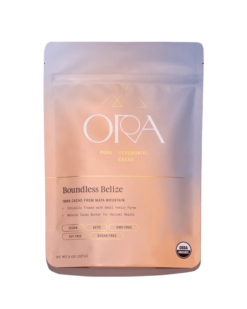 A bag of Ora Boundless Belize Ceremonial Cacao. The packaging is peach and blue.