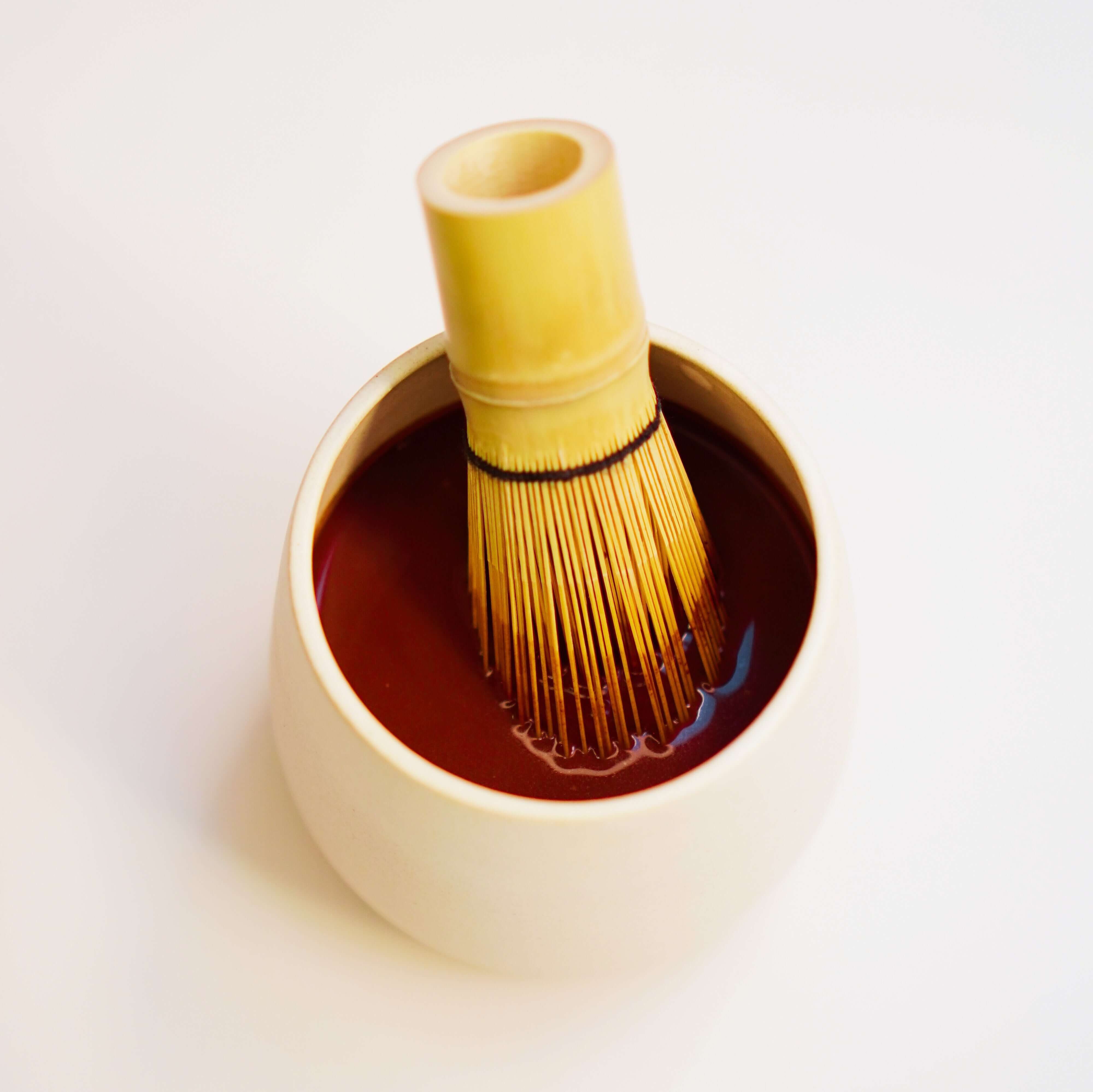 a yellowish white cup filled with Focus Ceremonial Cacao by Kaicao