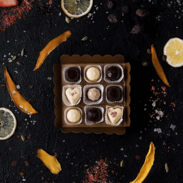 A box of MAYCHOCO speciality chocolates sitting on top of a table.