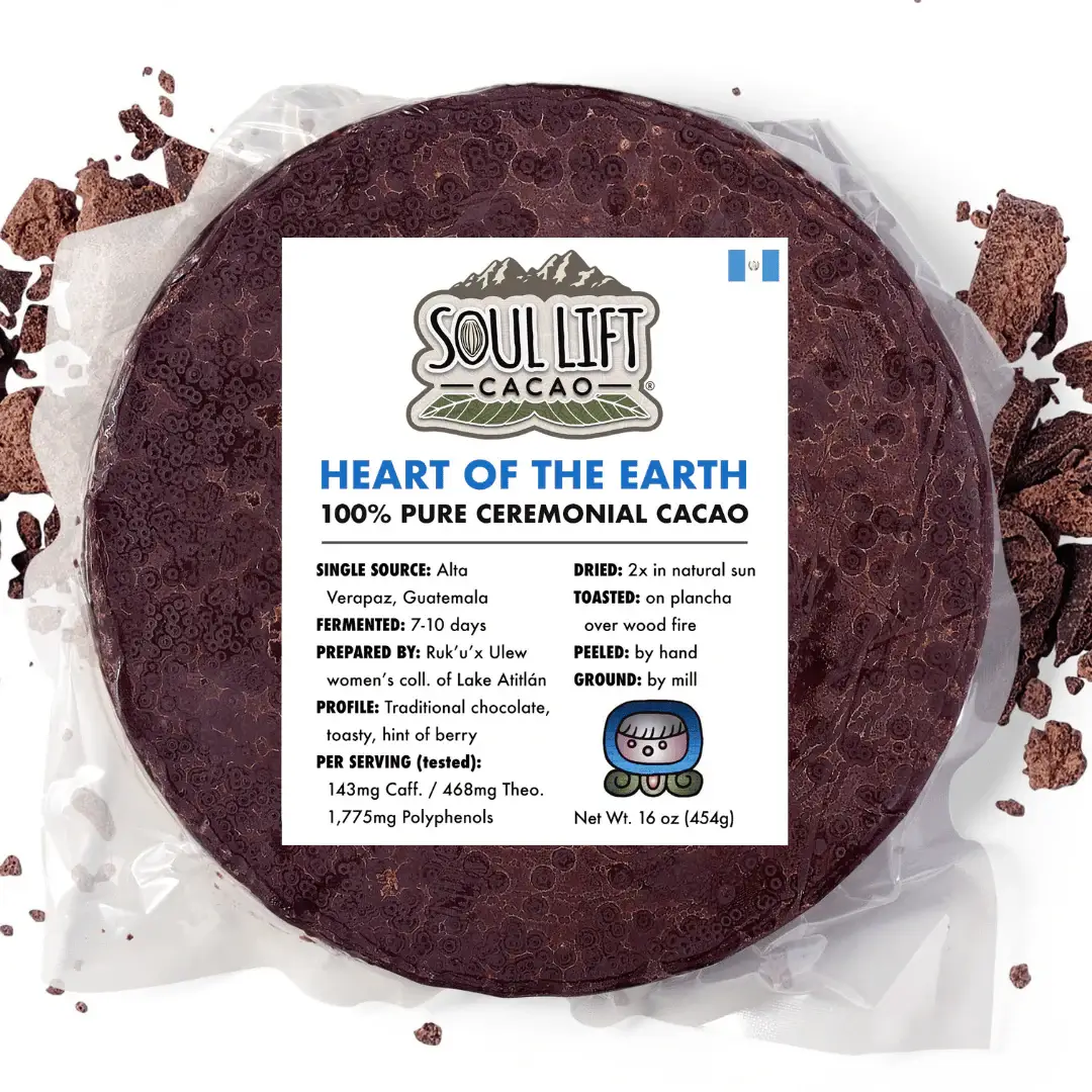 A round of Soul Lift Cacao Ceremonial Cacao Brick sitting on top of a piece of wax paper