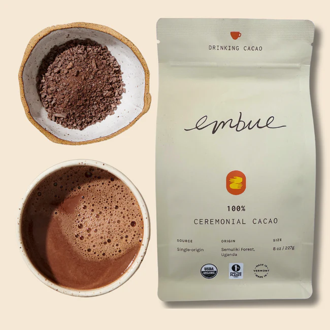A cup of drinking cacao next to a bag Embue Ceremonial Cacao Drinking Cacao Semuliki