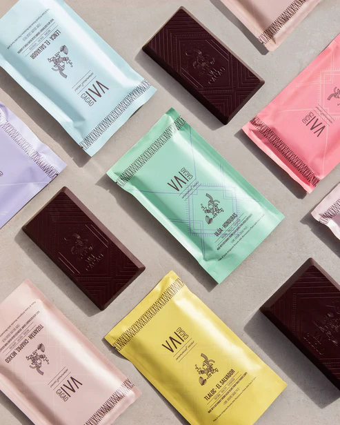 A variety of Vai Cacao Ceremonial Cacao bars laid out on a table.