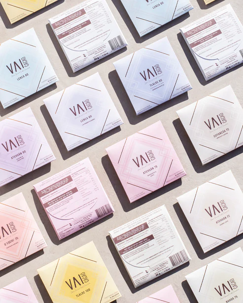 A variety of Vai Cacao Chocolate bars laid out on a table.