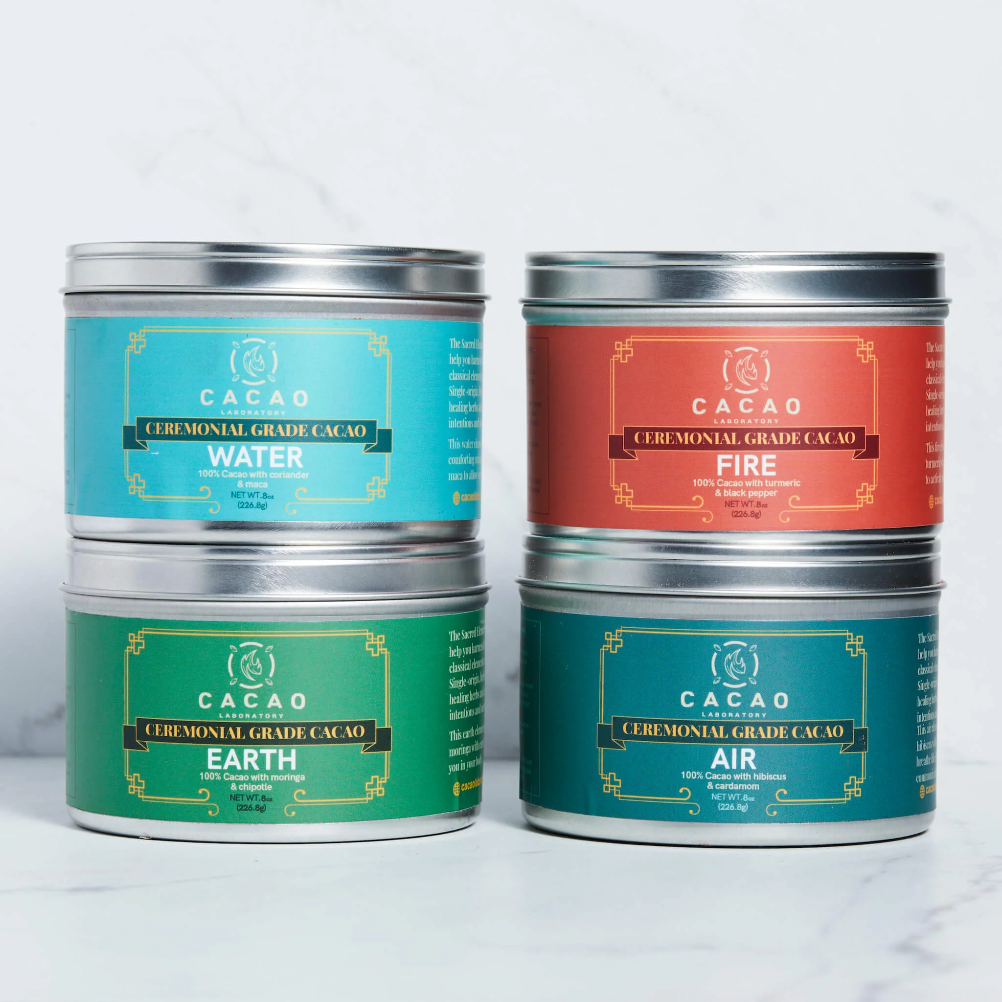 Four different tins of Cacao Laboratory Ceremonia Cacao sitting on a table.