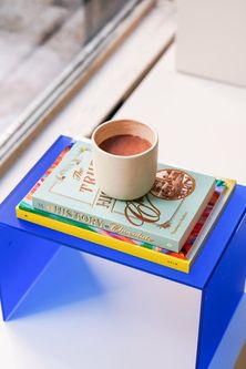 a cup of coffee on a stack of books