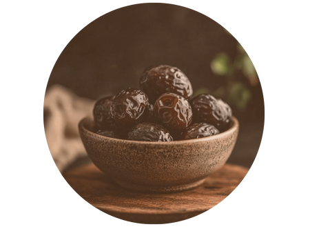 a bowl filled with raisins on top of a wooden table