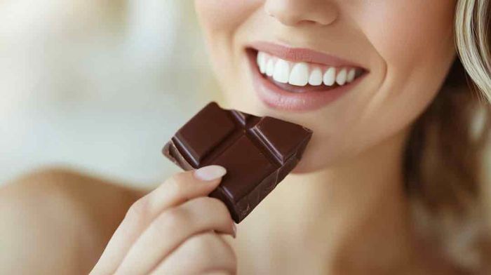 A woman holding a chocolate bar in her hand