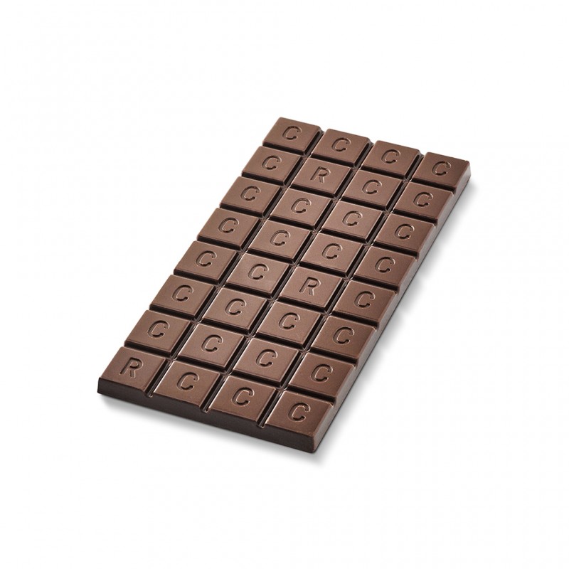 A close up of a chocolate bar on a white background. Each block is embossed with the letter C. 