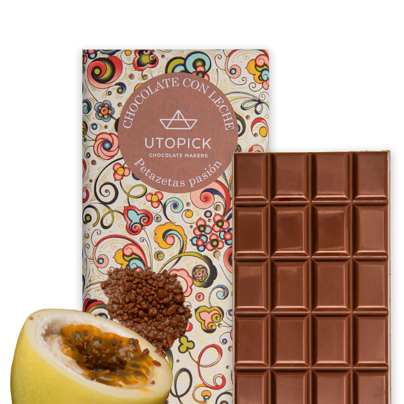 A chocolate bar with a piece of passion fruit next to it.