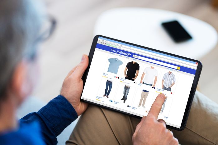 Man shopping for clothes on his tablet