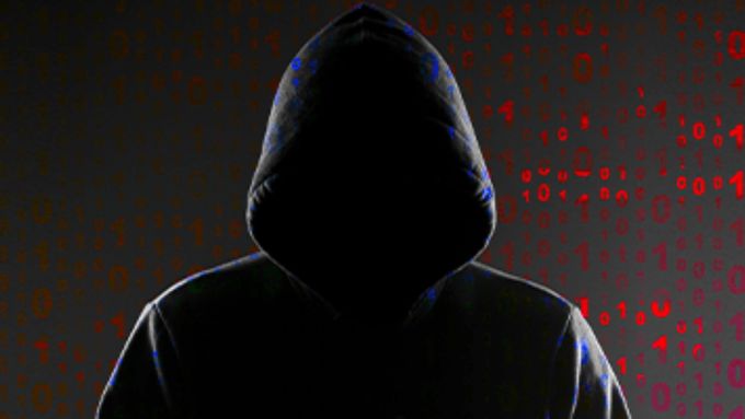 a person in a hoodie is standing in front of a red and black background