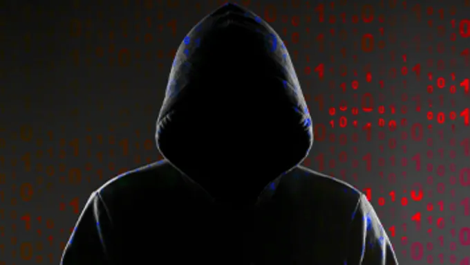 a hooded person standing in front of a red and black background