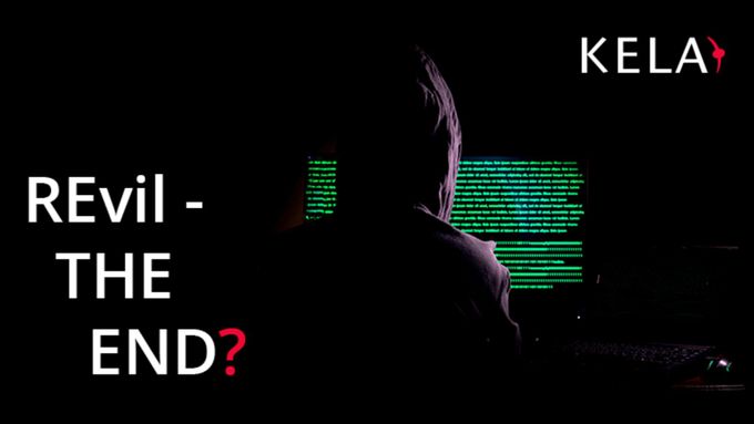 a person in a dark room with a computer screen