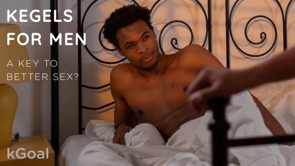 a shirtless man laying in a bed with a white sheet