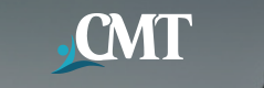 a man in a suit and tie standing in front of the cmt logo