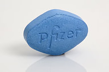 a blue pill pill sitting on top of a white table