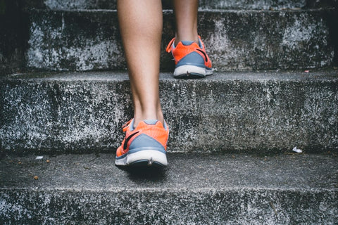 a close up of a person walking up some stairs