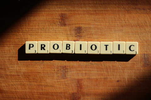 the word probiotic spelled with scrabble letters on a wooden surface
