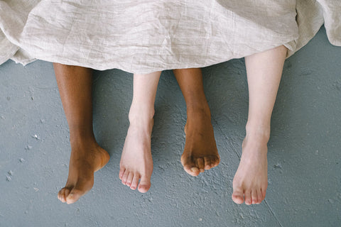 a person laying on a bed with their feet up