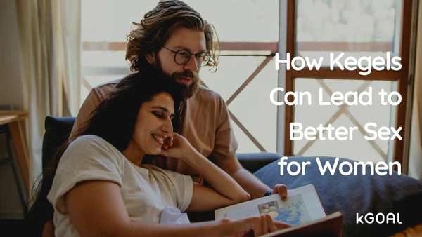 a man and woman sitting on a couch looking at a book