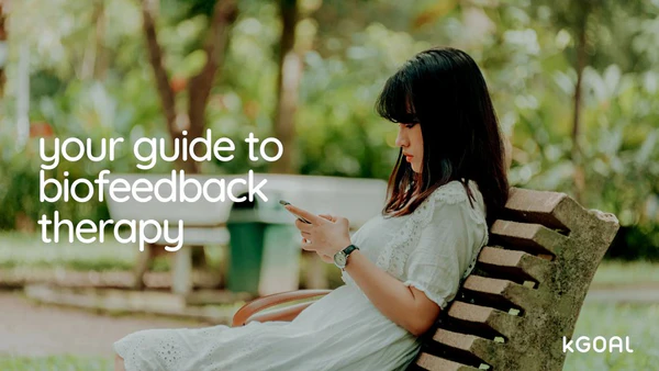 a woman sitting on a bench texting your guide to biofeedback therapy