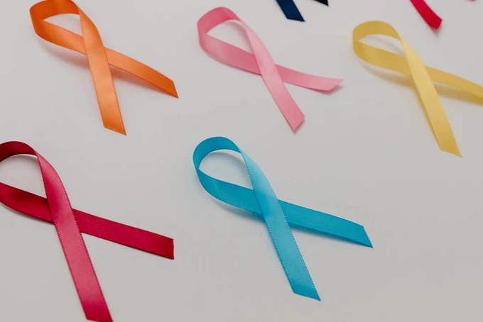 a group of different colored ribbons on a white surface
