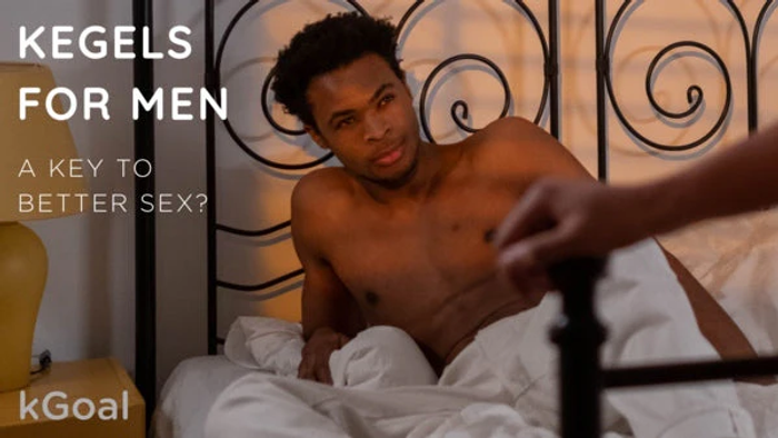 a shirtless man laying in a bed with a white sheet