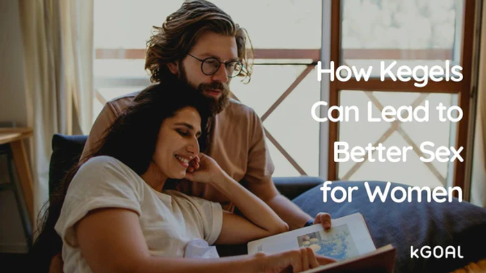 a man and woman sitting on a couch looking at a book