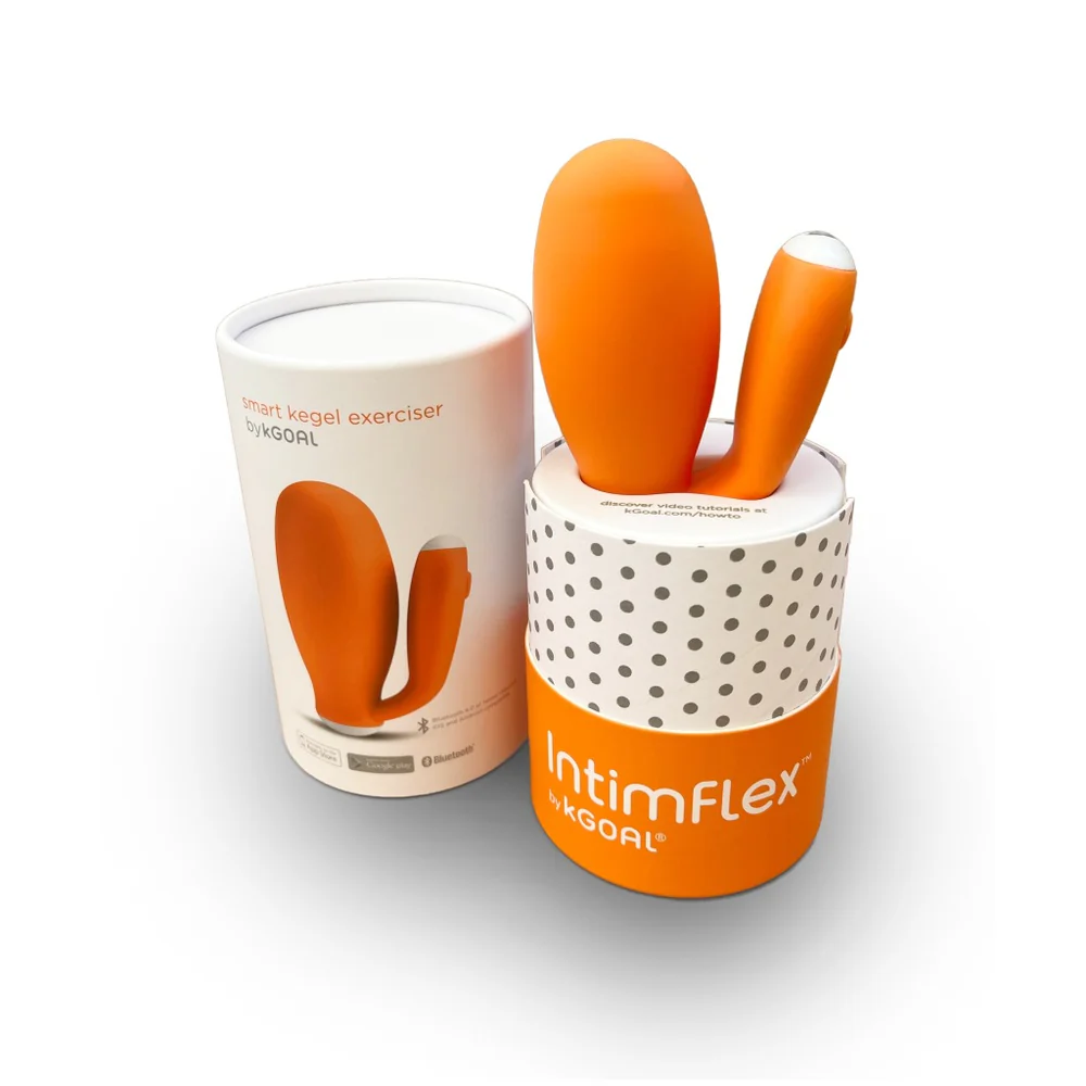 a cup with two orange utensils in it