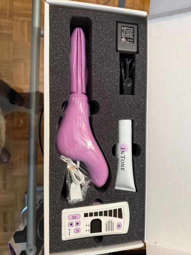 a pink hair dryer sitting inside of a box