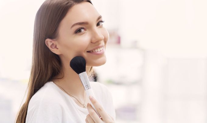 A woman with a brush in her hand.