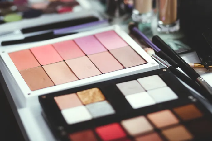 A close up of a makeup set on a table.